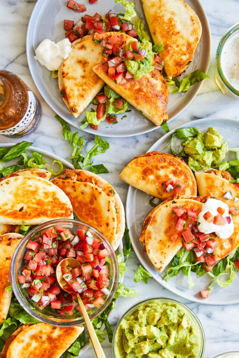 Mini Chicken Quesadillas - Crowd-pleasing snack-size quesadillas with refried beans, leftover rotisserie chicken + melted cheese! SO SO GOOD!