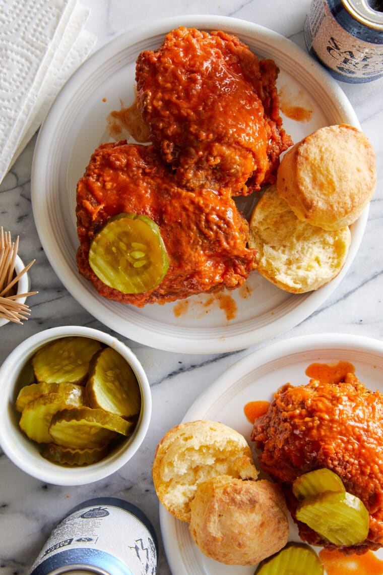 Nashville Hot Chicken - The most perfect crisp, crunchy, saucy fried chicken. Served with a buttery hot sauce, biscuits + dill pickle chips!